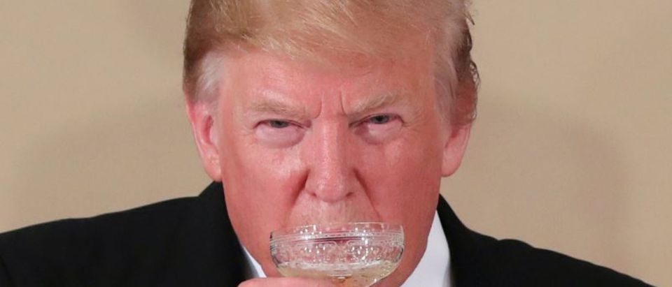 U.S. President Donald Trump drinks during a state banquet at the Imperial Palace in Tokyo, Japan May 27, 2019. REUTERS/Jonathan Ernst