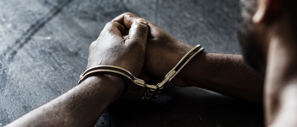 A man is in handcuffs. Shutterstock image via rawpixel.com