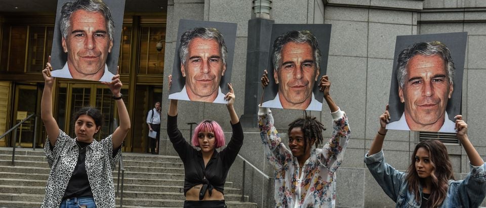 A protest group called "Hot Mess" hold up signs of Jeffrey Epstein in front of the Federal courthouse on July 8, 2019 in New York City. (Stephanie Keith/Getty Images)
