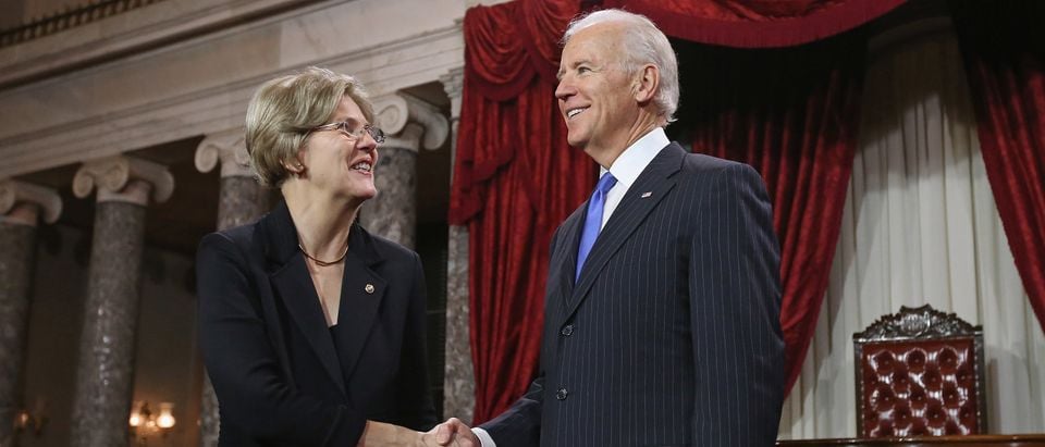 WASHINGTON, DC - JANUARY 03: U.S. Sen. Elizabeth Warren (D-MA) (L) participates in a reenacted swearing-in with U.S. Vice President Joe Biden in the Old Senate Chamber at the U.S. Capitol January 3, 2013 in Washington, DC. Biden swore in the newly-elected and re-elected senators earlier in the day on the floor of the current Senate chamber. (Photo by Chip Somodevilla/Getty Images)