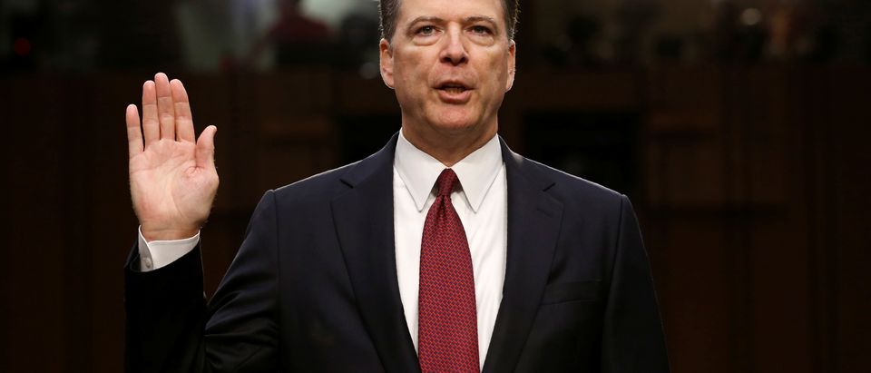 FILE PHOTO: Former FBI Director James Comey sworn in to testify at a hearing in Washington