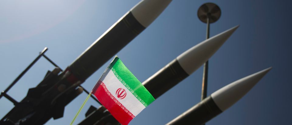 An Iranian flag is pictured next to missiles during a war exhibition to mark the anniversary of the Iran-Iraq war at Baharestan square near the Iranian Parliament in southern Tehran