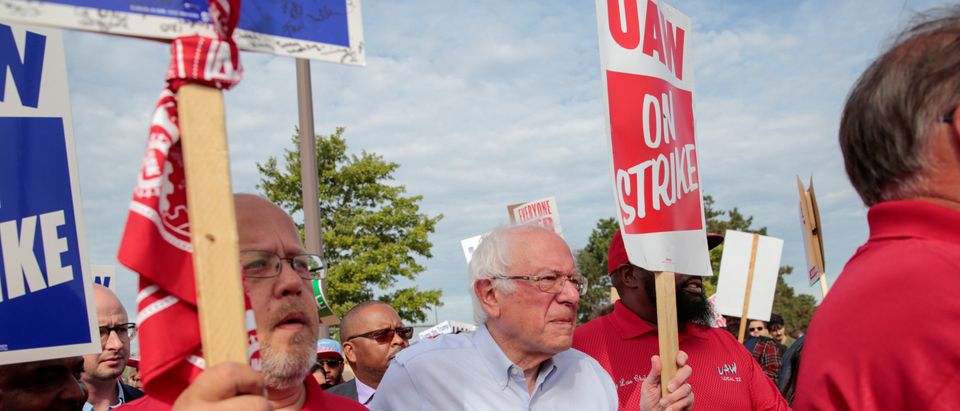 Democratic U.S. presidential candidate Senator Bernie Sanders carries a Strike sign with striking United Auto Workers (UAW) in Hamtramck,