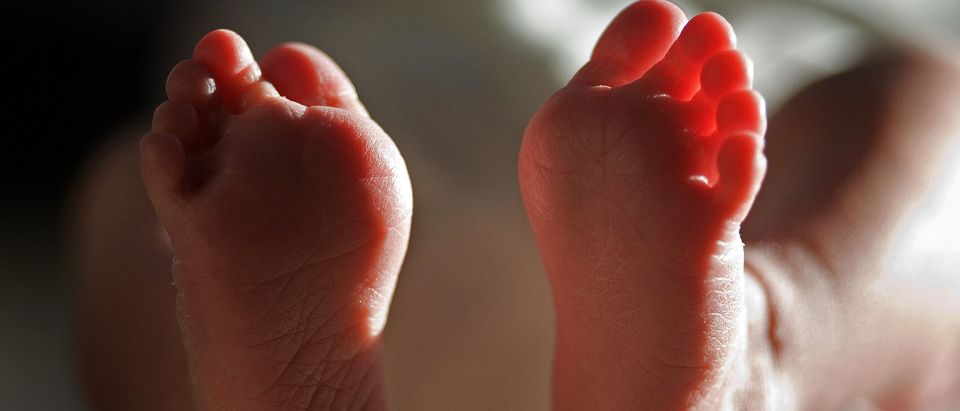 In this file photograph taken on March 20, 2007, a two-week-old boy finds his feet in his new world. Health Secretary Patricia Hewitt announced, April 3, 2007 that for the first time, mothers-to-be will have a guarantee that the NHS will provide them with a full range of birthing choices - including home births - and a midwife they know and trust to care for them. (Photo by Christopher Furlong/Getty Images)
