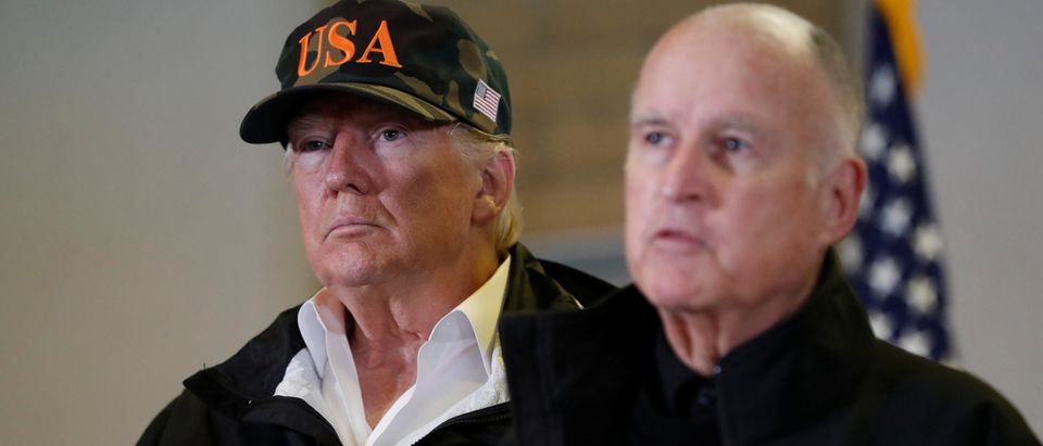 U.S. President Donald Trump looks on as California Governor Jerry Brown speaks during a briefing with State officials after visiting the charred wreckage of Skyway Villa Mobile Home and RV Park in Paradise, in Chico, California, U.S., November 17, 2018. REUTERS/Leah Millis