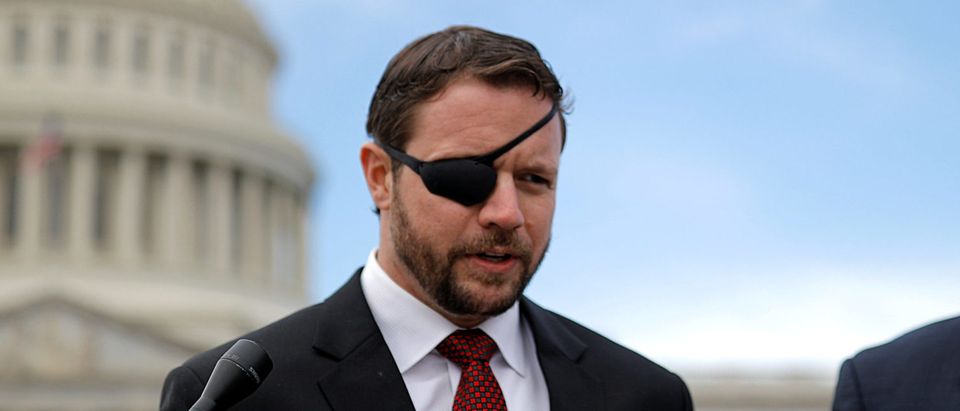 Republican Representative-elect Dan Crenshaw talks with reporters as he arrives for a class photo with incoming newly elected members of the U.S. House of Representatives on Capitol Hill in Washington, U.S., November 14, 2018. REUTERS/Carlos Barria