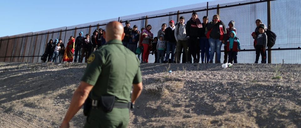 A group of Central American migrants surrenders to U.S. Border Patrol Agent Jose Martinez south of the U.S.-Mexico border fence in El Paso