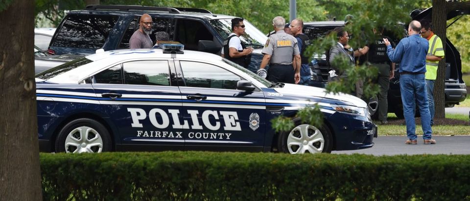 Police and first responders gather at the Gannett headquarters, home of USA Today, in McLean, Virginia, on August 7, 2019. - The newspaper USA Today evacuated its headquarters in northern Virginia on Wednesday following an alleged sighting of an armed man at the building, but later said the report was "mistaken. Fairfax County police said they had "found no evidence of any acts of violence or injuries." (Photo by ERIC BARADAT/AFP/Getty Images)