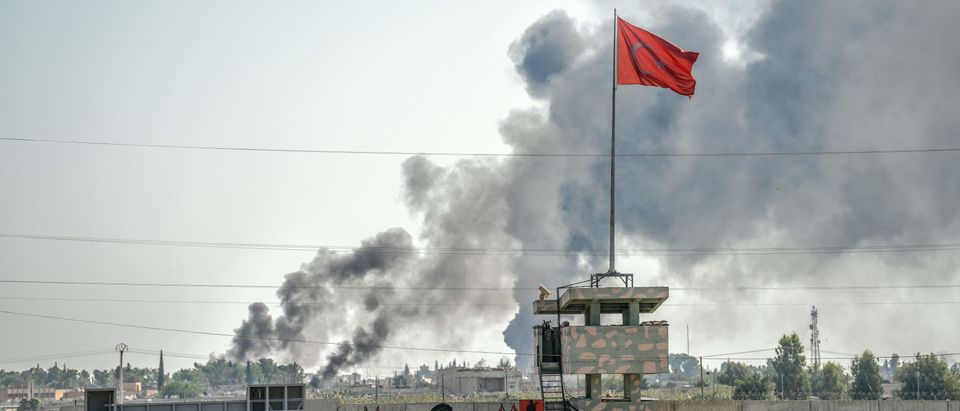 A picture taken in Akcakale at the Turkish border with Syria on Oct. 10, 2019 shows smokes rising from the Syrian town of Tal Abyad. (Photo by BULENT KILIC / AFP via Getty Images)
