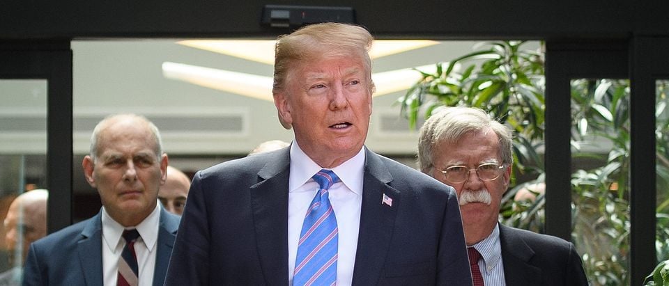 US President Donald Trump (C) leaves with Chief of Staff John Kelly (L) and National Security Advisor John Bolton (R) after holding a press conference ahead of his early departure from the G7 Summit on June 9, 2018 in La Malbaie, Canada. (Leon Neal/Getty Images)