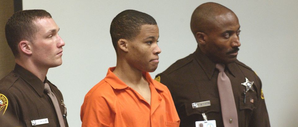 Lee Boyd Malvo is brought into court to be identified by a witness during the murder trial at the Virginia Beach Circuit Court on Oct. 22, 2003. (Davis Turner/Pool/Getty Images)