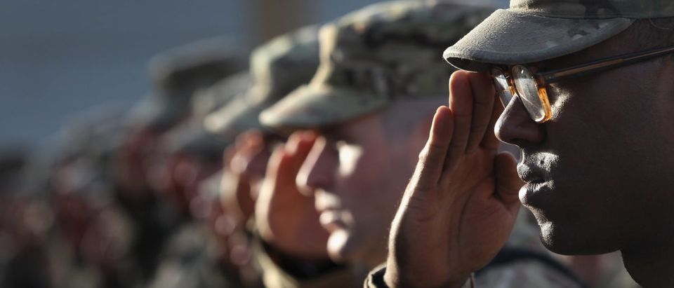 U.S. Army soldiers salute during the national anthem during the an anniversary ceremony of the terrorist attacks on Sept. 11, 2001 on Sept. 11, 2011 at Bagram Air Field, Afghanistan. Ten years after the 9/11 attacks in the United States and after almost a decade war in Afghanistan, American soldiers paid their respects in a solemn observence of the tragic day. (Photo by John Moore/Getty Images)