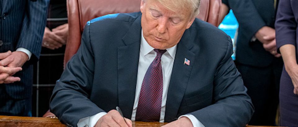 President Donald Trump signs the Cybersecurity and Infrastructure Security Agency Act in the Oval Office of the White House on November 16, 2018