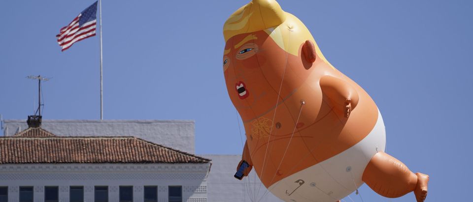 Protesters fly a giant Baby Trump balloon next to the hotel where U.S. President Donald Trump is holding a fundraising luncheon in San Diego, California, U.S., September 18, 2019. REUTERS/Mike Blake