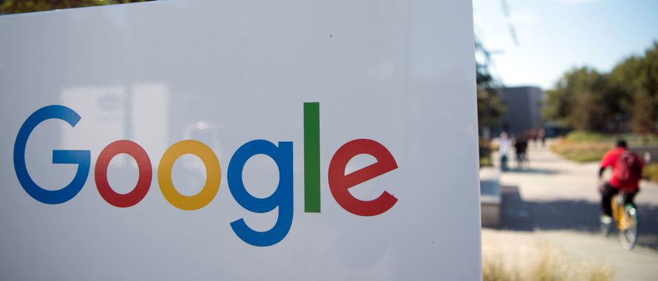 A man rides a bike passed a Google sign and logo at the Googleplex in Menlo Park, California on Nov. 4, 2016. (Photo: JOSH EDELSON/AFP via Getty Images)