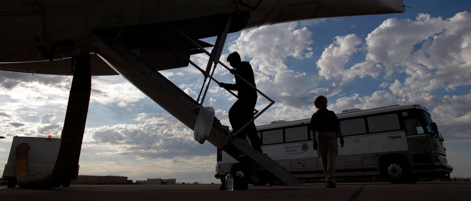 A Guatemalan illegal immigrant boards a plane at a flight operation unit at Mesa airport during his deportation process in Phoenix