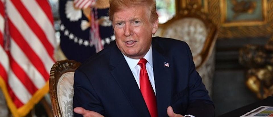 President Donald Trump answers questions from reporters after making a video call to the troops stationed worldwide at the Mar-a-Lago estate in Palm Beach Florida, on December 24, 2019