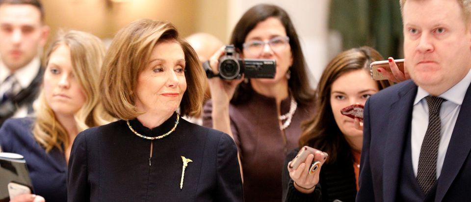 House Speaker Nancy Pelosi is followed by members of the news media inside Statuary Hall prior to votes in the U.S. House of Representatives on two articles of impeachment against U.S. President Donald Trump on Capitol Hill in Washington, U.S., Dec. 18, 2019. (REUTERS/Tom Brenner)