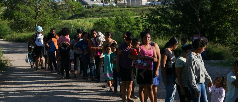 Migrants, most of them asylum seekers sent back to Mexico from the U.S. under the "Remain in Mexico" program officially named Migrant Protection Protocols (MPP), wait in line to receive bottles of drinking water by a makeshift encampment in Matamoros, Tamaulipas, Mexico, Oct. 28, 2019. REUTERS/Loren Elliott