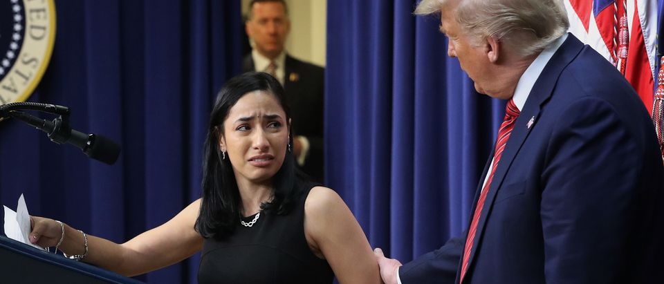 U.S. President Donald Trump (R) comforts Daria Ortiz, granddaughter of murder victim Maria Fuertes, after she spoke during an event with the National Border Patrol Council in the South Court Auditorium in the Eisenhower Executive Office Building Feb. 14, 2020 in Washington, D.C. (Photo by Chip Somodevilla/Getty Images)
