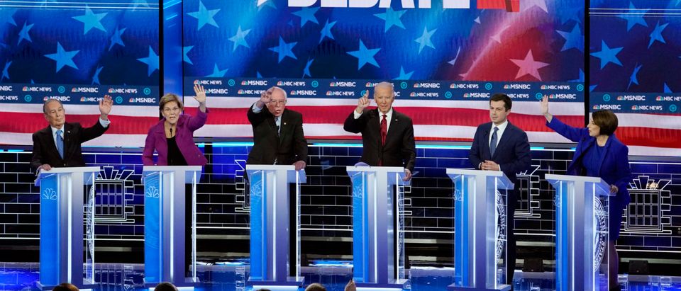 All of his rivals raise their hands to speak as former South Bend Mayor Pete Buttigieg answers a question at the ninth Democratic 2020 U.S. Presidential candidates debate at the Paris Theater in Las Vegas
