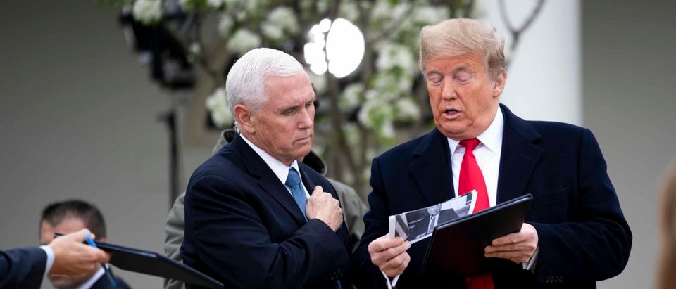 WASHINGTON, DC - MARCH 24: U.S. President Donald Trump and Vice President Mike Pence look over some notes as they participate in a Fox News Virtual Town Hall with Anchor Bill Hemmer, in the Rose Garden of the White House on March 24, 2020 in Washington, DC. Cases of COVID-19 continue to rise in the United States, with New York's case count doubling every three days according to governor Andrew Cuomo. (Photo by Doug Mills-Pool/Getty Images)
