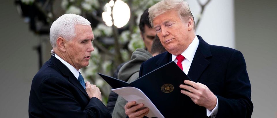 WASHINGTON, DC - MARCH 24: U.S. President Donald Trump and Vice President Mike Pence look over some notes as they participate in a Fox News Virtual Town Hall with Anchor Bill Hemmer, in the Rose Garden of the White House on March 24, 2020 in Washington, DC. Cases of COVID-19 continue to rise in the United States, with New York's case count doubling every three days according to governor Andrew Cuomo. (Photo by Doug Mills-Pool/Getty Images)