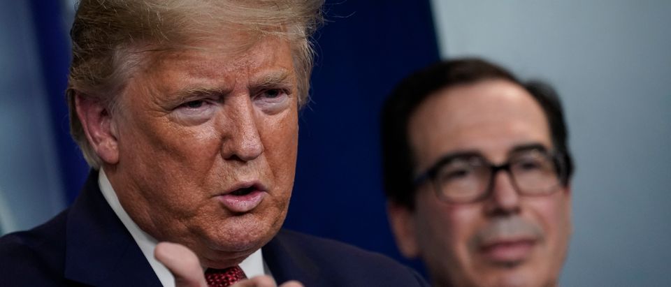 U.S. President Donald Trump, joined by Secretary of the Treasury Steven Mnuchin, speaks during a briefing on the coronavirus pandemic, in the press briefing room of the White House on March 25, 2020 in Washington, DC. (Drew Angerer/Getty Images)