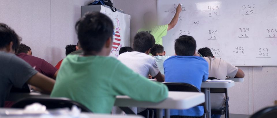 A teacher instructs mathematics at the HHS unaccompanied minors migrant detention facility at Carrizo Springs