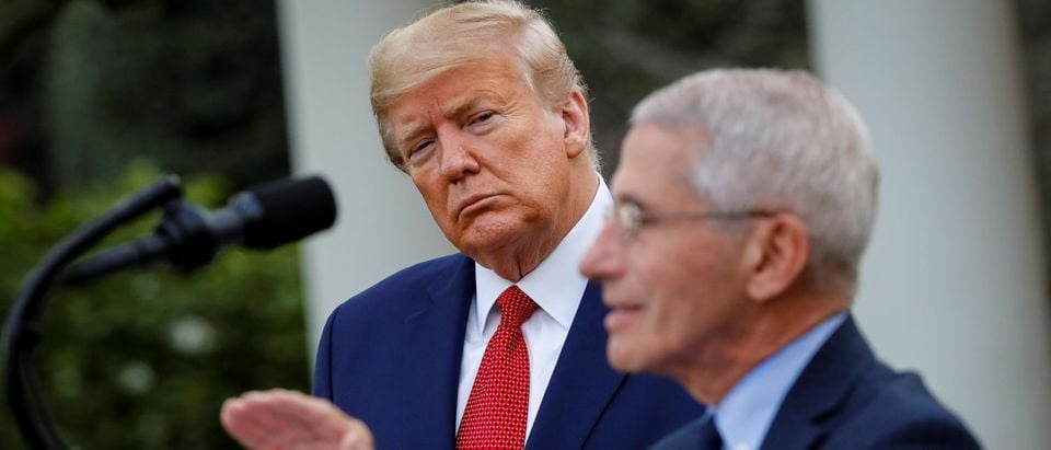 NIH National Institute of Allergy and Infectious Diseases Director Anthony Fauci speaks as U.S. President Donald Trump listens during a news conference in the Rose Garden of the White House in Washington, U.S., March 29, 2020. REUTERS/Al Drago