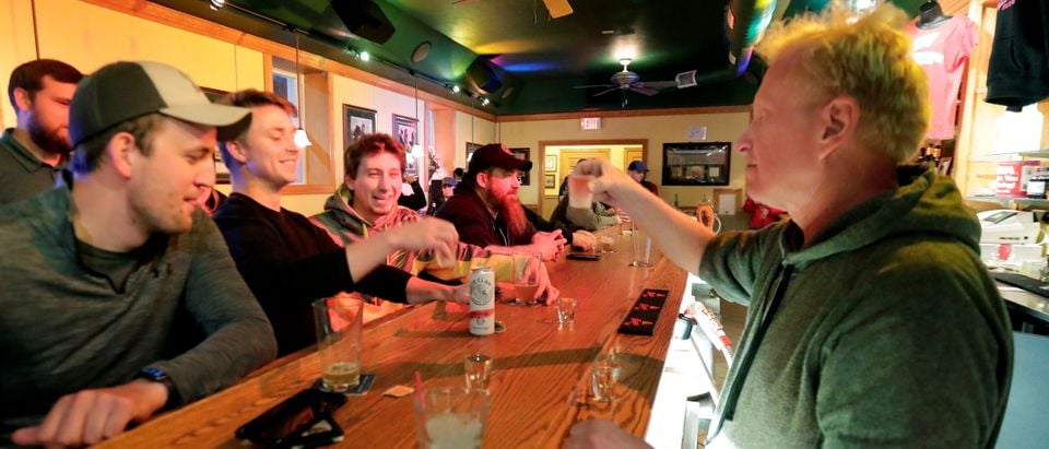 Owner Michael Mattson toasts the re-opening of the Friends and Neighbors bar in Appleton