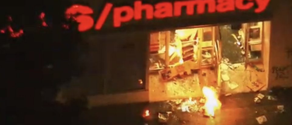 Screenshot of YouTube clip showing pharmacy burning (YouTube screenshot/NBC News)