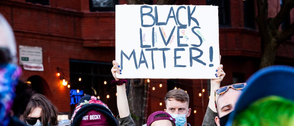 CHICAGO, ILLINOIS - JUNE 14: A protester holds a sign during a march in support of Black Lives Matter and Black Trans Lives in Boystown on June 14, 2020 in Chicago, Illinois. Protests erupted across the nation after George Floyd died in police custody in Minneapolis, Minnesota on May 25th. (Photo by Natasha Moustache/Getty Images)