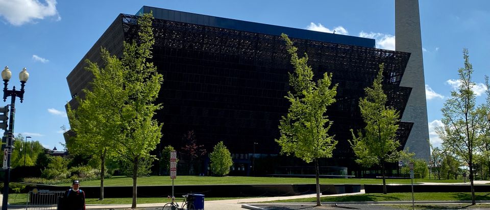 A man crosses the street on April 18, 2020, near the closed National Museum of African American History public due to COVID-19 (coronavirus) in Washington, DC. (Photo by DANIEL SLIM/AFP via Getty Images)