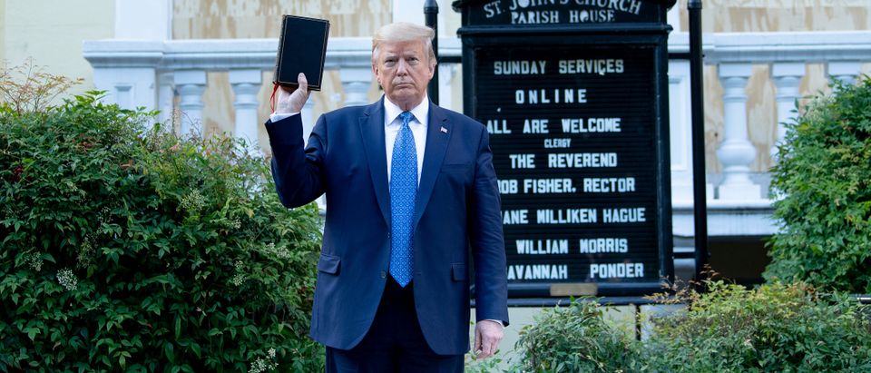 US President Donald Trump holds a Bible while visiting St. John's Church across from the White House after the area was cleared of people protesting the death of George Floyd June 1, 2020, in Washington, DC. - US President Donald Trump was due to make a televised address to the nation on Monday after days of anti-racism protests against police brutality that have erupted into violence. The White House announced that the president would make remarks imminently after he has been criticized for not publicly addressing in the crisis in recent days. (Photo by BRENDAN SMIALOWSKI/AFP via Getty Images)