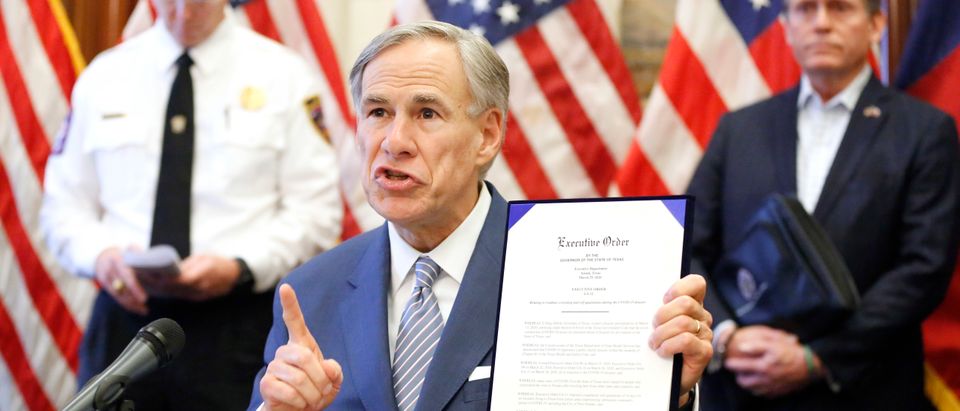 AUSTIN, TX - MARCH 29: During a press conference at the Texas State Capitol in Austin, Texas Governor Greg Abbott holds a new executive order stating that travel from other states will be limited and subject to 14-day self quarantine, Sunday, March 29, 2020. He also announced the US Army Corps of Engineers and the state are putting up a 250-bed field hospital at the Kay Bailey Hutchison Convention Center in downtown Dallas The space can expand to nearly 1,400 beds. Joining him are Texas Division of Emergency Management Chief Nim Kidd (left) and former State Representative Dr. John Zerwas (right). (Phopto by Tom Fox-Pool/Getty Images)