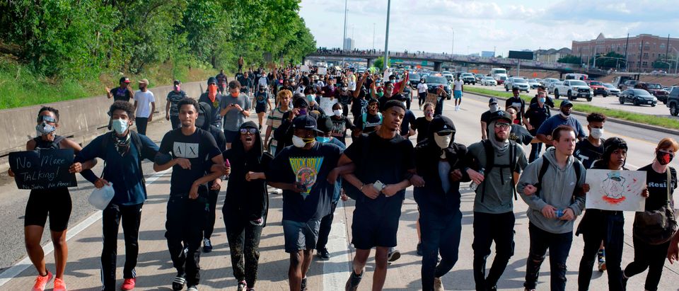Protesters march during a demonstration over the death of George Floyd, a black man who died after a white policeman kneeled on his neck for several minutes in Houston, Texas on May 29, 2020. - Demonstrations are being held across the US after George Floyd died in police custody on May 25. (Photo by Mark Felix / AFP) (Photo by MARK FELIX/AFP /AFP via Getty Images)