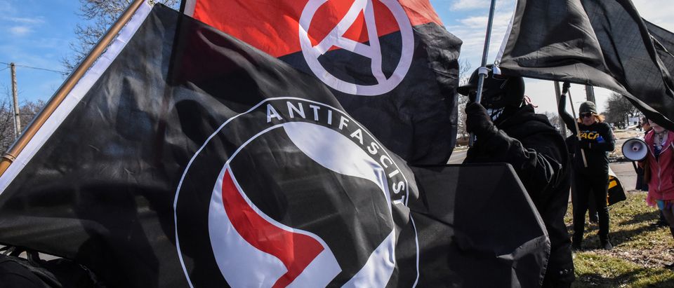 MMembers of the Great Lakes anti-fascist organization (Antifa) fly flags during a protest against the Alt-right outside a hotel in Warren, Michigan, U.S., March 4, 2018. REUTERS/Stephanie Keith - RC1B5E31E310embers of the Great Lakes anti-fascist organization (Antifa) fly flags during a protest against the Alt-right outside a hotel in Warren, Michigan