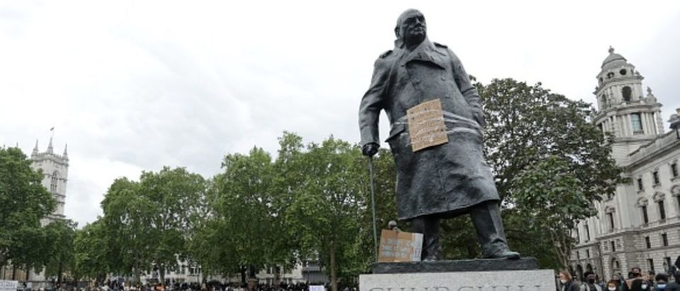 TOPSHOT - The statue of former British prime minister Winston Churchill is seen defaced, with the words (Churchill) "was a racist" written on it's base in Parliament Square, central London after a demonstration outside the US Embassy, on June 7, 2020, organised to show solidarity with the Black Lives Matter movement in the wake of the killing of George Floyd, an unarmed black man who died after a police officer knelt on his neck in Minneapolis. - Taking a knee, banging drums and ignoring social distancing measures, outraged protesters from Sydney to London on Saturday kicked off a weekend of global rallies against racism and police brutality. (Photo by ISABEL INFANTES / AFP) (Photo by ISABEL INFANTES/AFP via Getty Images)