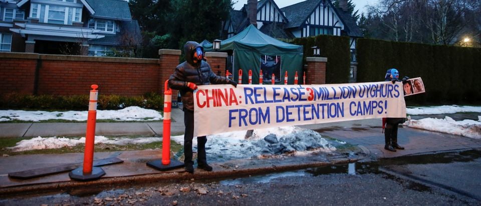 People protest against the Uighur camps in China outside the home of Huawei Chief Financial Officer Meng Wanzhou before her extradition hearing in Vancouver