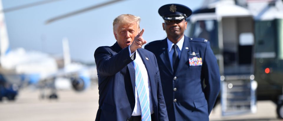 US President Donald Trump(L) points before boarding Air Force One on July 29, 2020 at Andrews Air Force Base, Maryland en route to Texas. (Photo by NICHOLAS KAMM/AFP via Getty Images)
