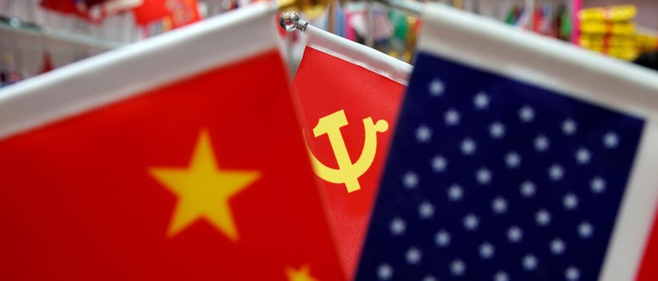 The flags of China, U.S. and the Chinese Communist Party are displayed in a flag stall at the Yiwu Wholesale Market in Yiwu
