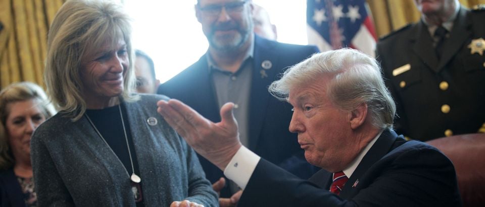 WASHINGTON, DC - MARCH 15: U.S. President Donald Trump (R) greets Angel Mom Mary Ann Mendoza (L) of Mesa Arizona, during an event on border security in the Oval Office of the White House March 15, 2019 in Washington, DC. President Trump has vetoed the congressional resolution that blocks his national emergency declaration on the southern border. (Photo by Alex Wong/Getty Images)