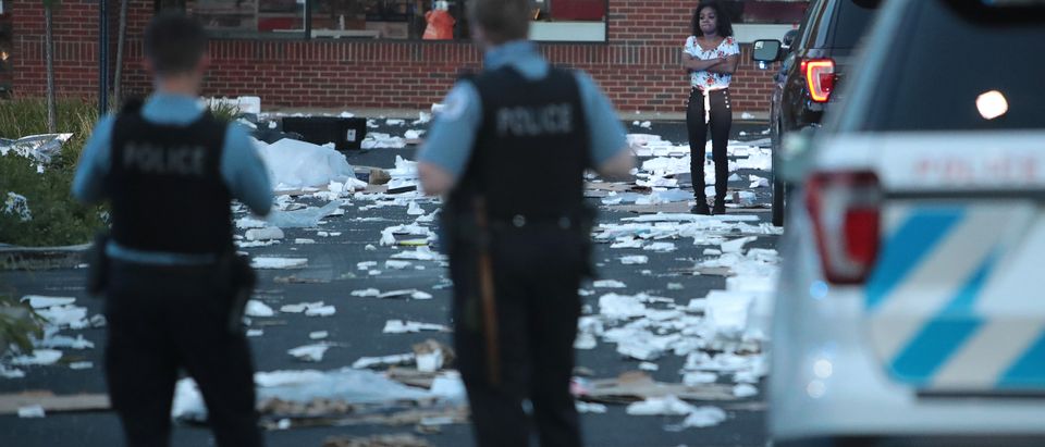 A person stands near a looted store after parts of the city had widespread looting and vandalism, on August 10, 2020 in Chicago, Illinois. (Scott Olson/Getty Images)