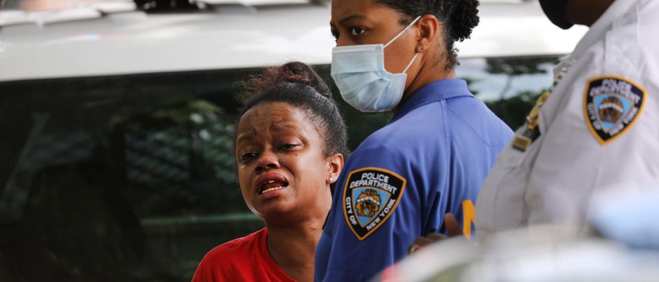NEW YORK, NEW YORK - JULY 07: A woman who knew the victim cries at the scene of an afternoon shooting that left one person dead on July 07, 2020 in the Brooklyn borough of New York City. New York City has witnessed a surge in gun violence over the past month with 9 people killed, including children, and 41 others wounded on the Fourth of July weekend alone. The gun violence is occurring against the backdrop of a nationwide movement to consider defunding police departments. (Photo by Spencer Platt/Getty Images)