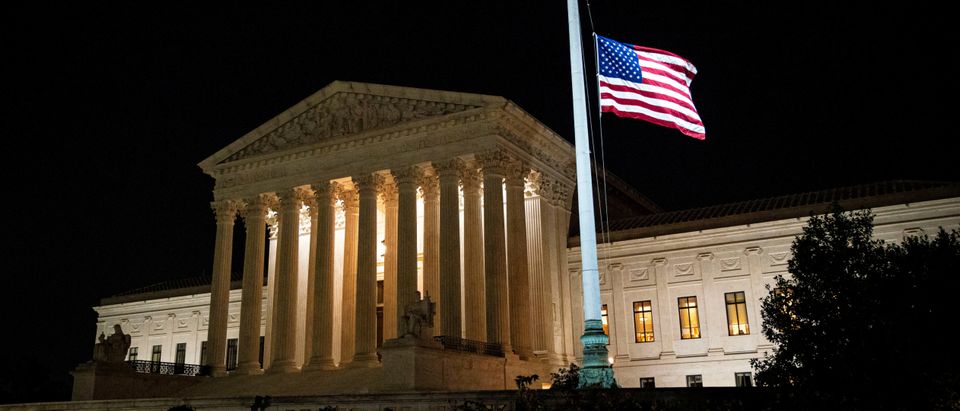 The American flag flies at half staff following the death of U.S. Supreme Court Justice Ruth Bader Ginsburg, outside of the U.S. Supreme Court, in Washington