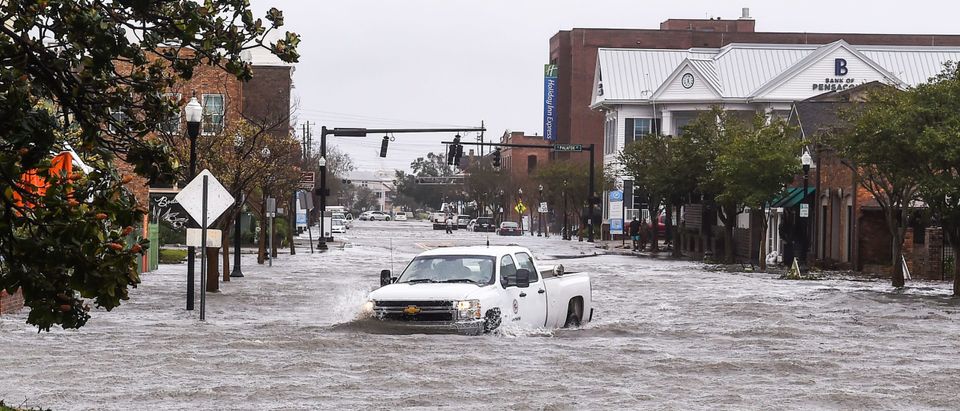 A city worker drives through the flooded street during Hurricane Sally in downtown Pensacola, Florida on September 16, 2020. - Hurricane Sally barrelled into the US Gulf Coast early Wednesday, with forecasts of drenching rains that could provoke "historic" and potentially deadly flash floods.The National Hurricane Center (NHC) said the Category 2 storm hit Gulf Shores, Alabama at about 4:45 am (0945 GMT), bringing maximum sustained winds of about 105 miles (165 kilometers) per hour."Historic life-threatening flooding likely along portions of the northern Gulf coast," the Miami-based center had warned late Tuesday, adding the hurricane could dump up to 20 inches (50 centimeters) of rain in some areas. (Photo by Chandan Khanna/AFP via Getty Images)