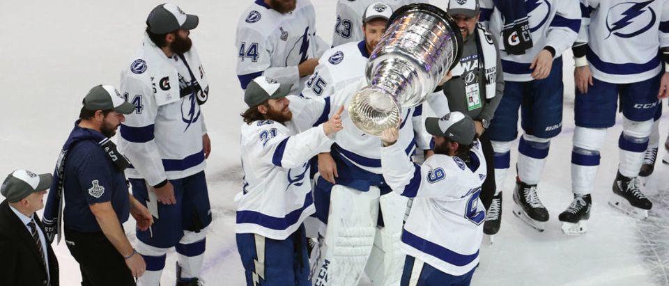 EDMONTON, ALBERTA - SEPTEMBER 28: Tyler Johnson #9 of the Tampa Bay Lightning hands off the Stanley Cup to Brayden Point #21 following the series-winning victory over the Dallas Stars in Game Six of the 2020 NHL Stanley Cup Final at Rogers Place on September 28, 2020 in Edmonton, Alberta, Canada. (Photo by Bruce Bennett/Getty Images)