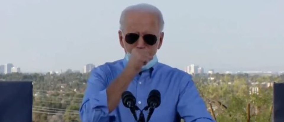 Biden pulls down mask to cough (Twitter screengrab)