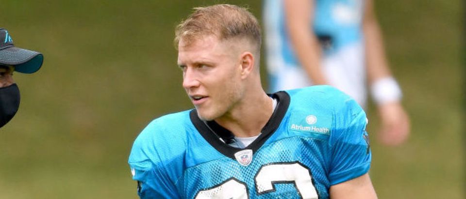CHARLOTTE, NORTH CAROLINA - AUGUST 24: Christian McCaffrey #22 of the Carolina Panthers talks with a coach during a training camp session at Bank of America Stadium on August 24, 2020 in Charlotte, North Carolina. (Photo by Grant Halverson/Getty Images)